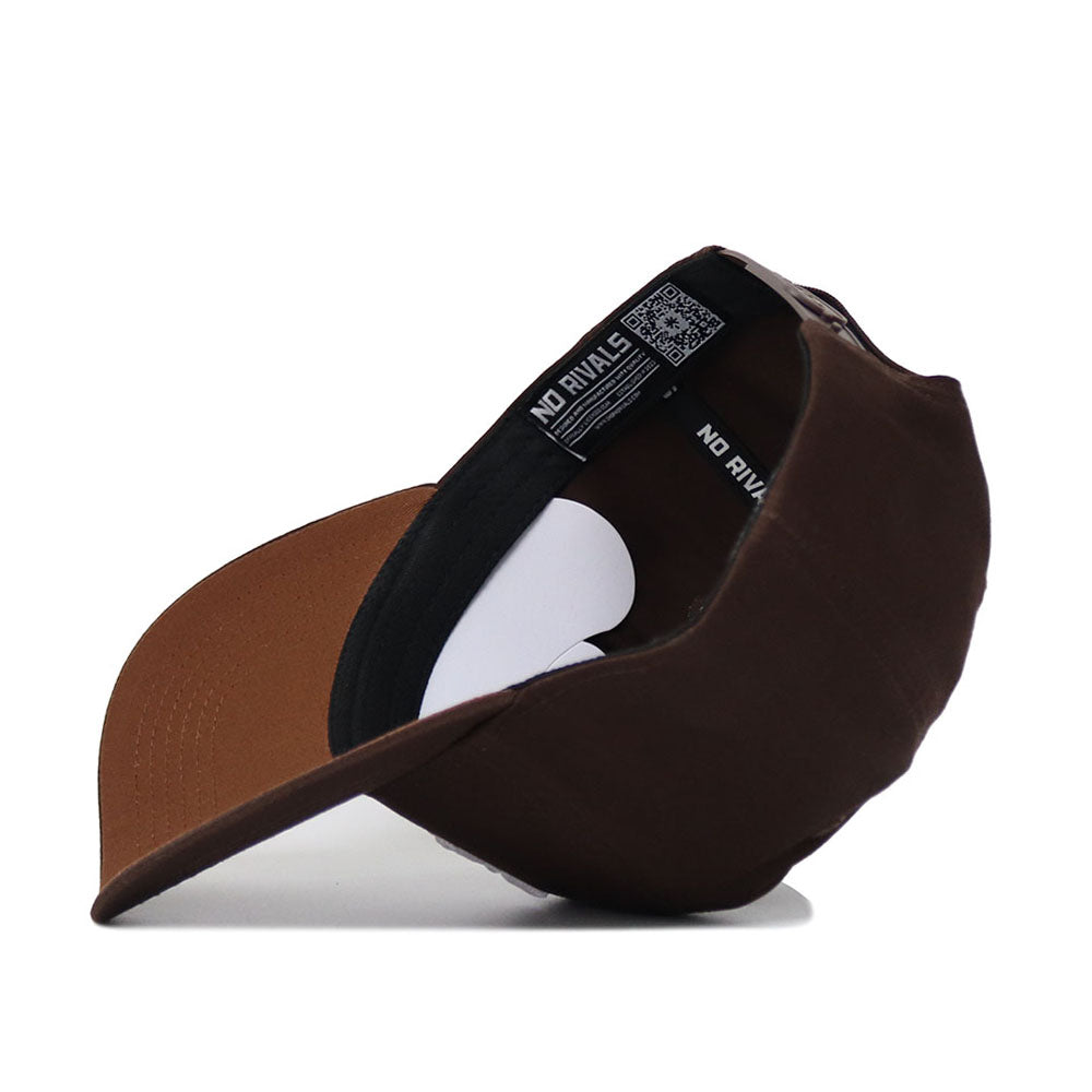 A brown cotton Texas A&M Americano Hat is shown inside out, revealing its black inner lining, white tags, and a curved brim. The label inside reads NO RIVALS.