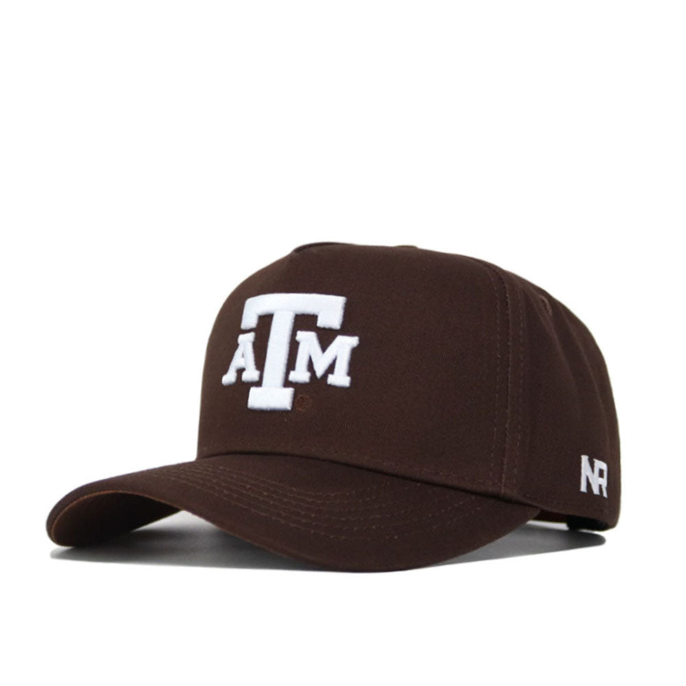 The Texas A&M Americano Hat is a brown cotton baseball cap with white embroidered ATM letters on the front and a small white N R logo on the side of the bill.
