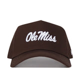 The Ole Miss Americano Hat is a brown, high-quality cotton baseball cap with "Ole Miss" embroidered in white script on the front.