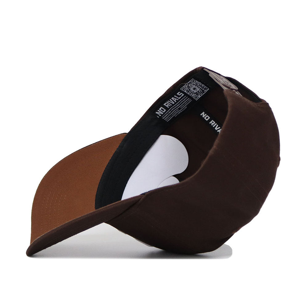 The Syracuse Americano Hat, shown upside down, displays its brown and black snapback style. The visible "NO RIVAL" inner label highlights its structured fit and high quality cotton construction.