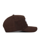 The TCU Americano Hat is a brown, structured-fit snapback cap with a curved brim and subtle white design on the front panel. Made from high-quality cotton, it stands out against a plain white background when viewed from the side.