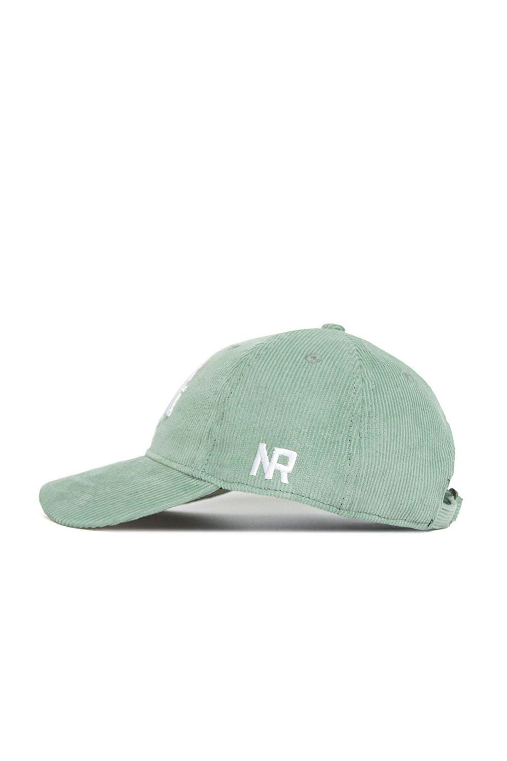 The No Rivals Texas A&M Corduroy Hat in Spring Green features white embroidered initials "NR" on the side, a curved brim, and an adjustable strap at the back for a perfect fit. Shown here from the left.