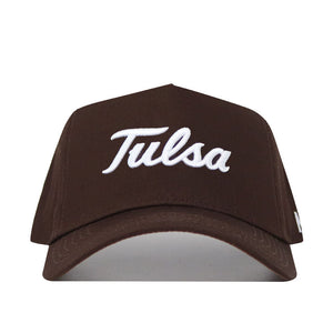 The Tulsa Americano Hat is a brown structured-fit cap crafted from high quality cotton with "Tulsa" embroidered in white cursive on the front.