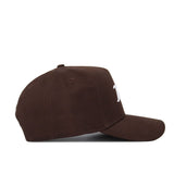 The Tulsa Americano Hat is a brown, structured-fit cap crafted from high-quality cotton, shown side-on with a curved brim and a partially visible white embroidered letter on the front, set against a plain white background.