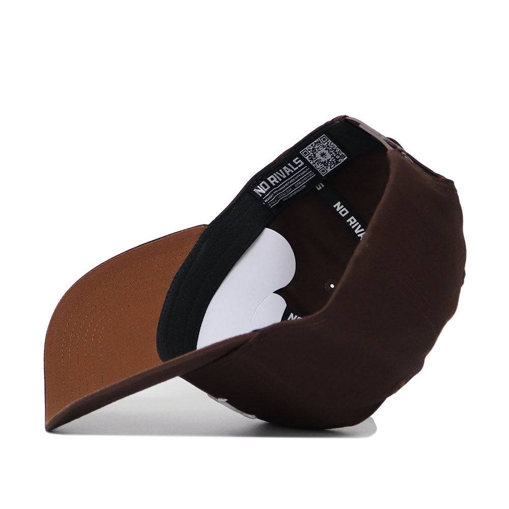 The Tulsa Americano Hat, a brown structured snapback crafted from high-quality cotton, is displayed upside down to show the brim, black inner band with "NO RIVALS" text, QR code, and white and brown interior details.