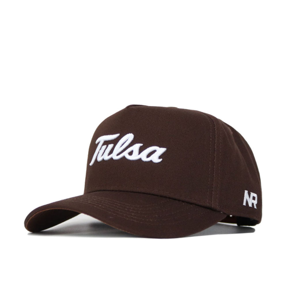 The Tulsa Americano Hat is a brown, high-quality cotton baseball cap with "Tulsa" in white script on the front and "NR" embroidered in white on the side, featuring a structured fit design.