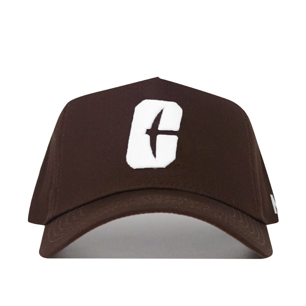 The UNC Charlotte Americano Hat is a brown snapback featuring a bold white "C" with a vertical cutout on the front, crafted from high-quality cotton. Shown on a plain white background.