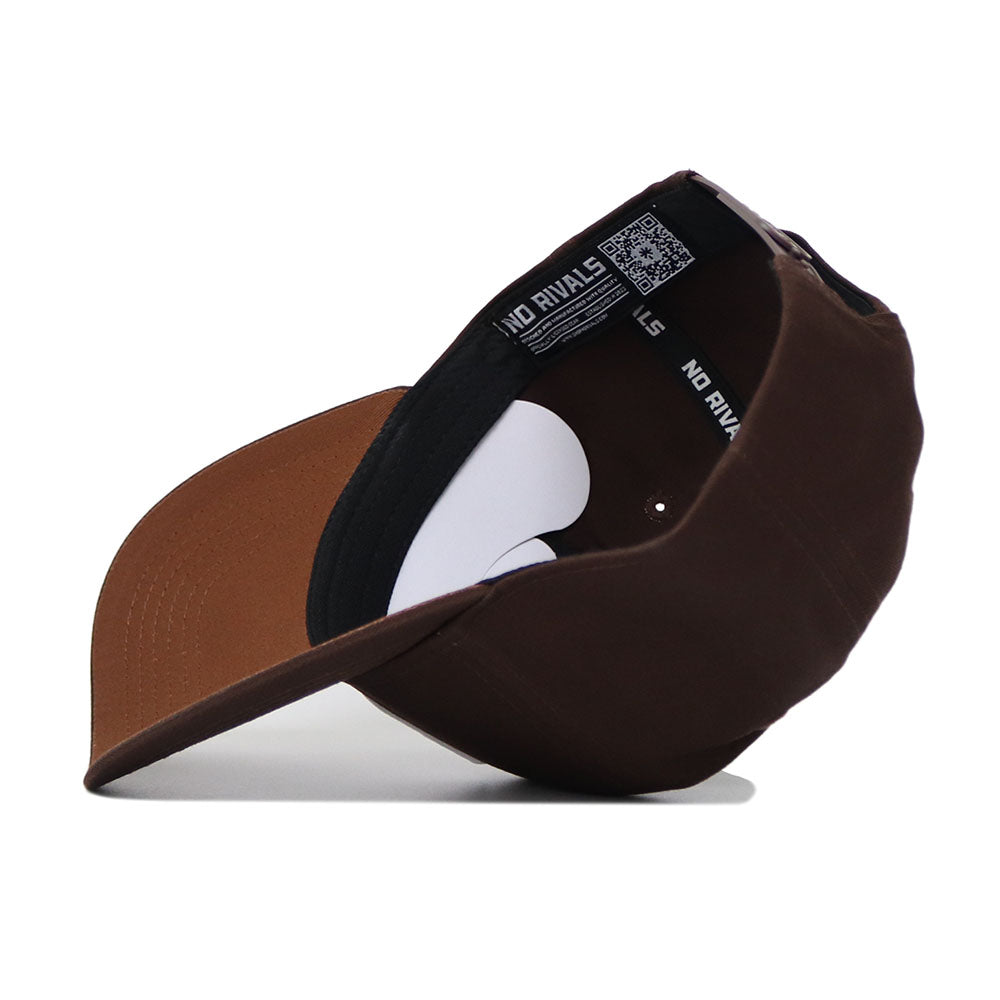 The UNC Charlotte Americano Hat is a brown snapback shown upside down, displaying its inner NO RIVALS band. Made from high-quality cotton, it features a matching brown underbill for comfort and durability.