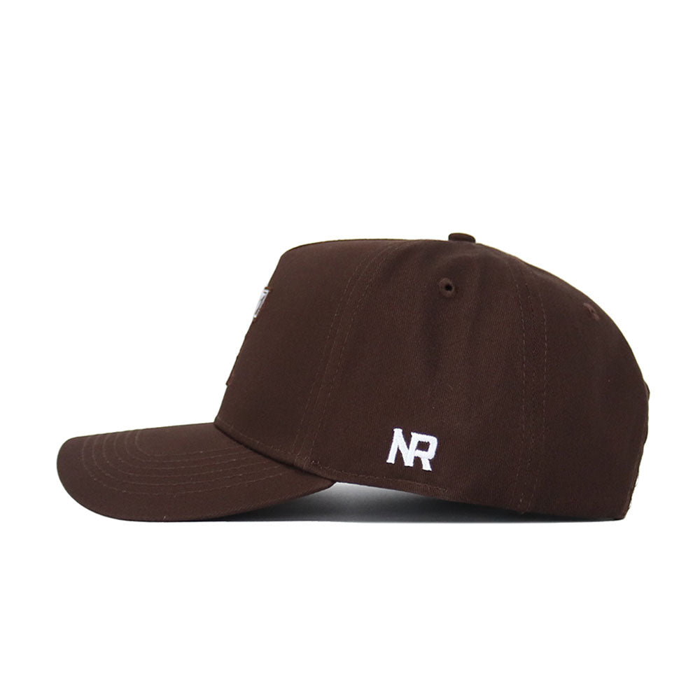The Texas Tech Americano Hat is a brown baseball cap seen from the side, with white “NR” stitched on the panel. Made of high-quality cotton, it features a curved brim, a plain crown, and an adjustable snapback closure for comfort.