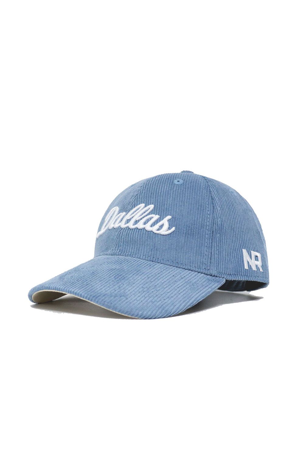 The Dallas Corduroy Hat - Unstructured - Sky Blue by No Rivals features white "Dallas" script on the front, NR on the side, a 6-panel unstructured design, curved brim, structured crown, and adjustable strap for a perfect fit.