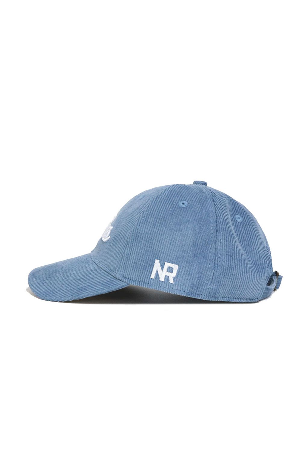 The No Rivals Dallas Corduroy Hat - Unstructured - Sky Blue (B2B) features a 6-panel design with white embroidered NR letters on the side, shown in a left side profile view.