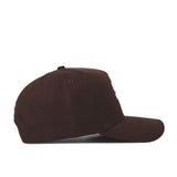 The Sam Houston State Americano Hat, a brown cotton baseball cap, is shown from the side on a white background with a curved brim, top button, and partially visible white embroidered front details.