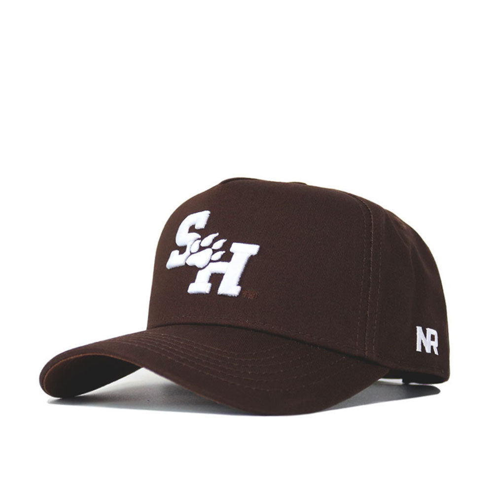 The Sam Houston State Americano Hat is a brown cotton baseball cap with a white SH logo and paw print on the front, NR stitched on the side, and an adjustable snap back for comfort.