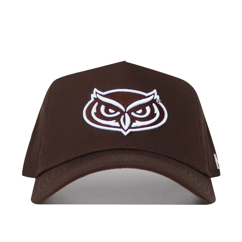 The Florida Atlantic (FAU) Americano Hat is a brown snapback featuring a white outlined owl face logo embroidered on the front. Made from high quality cotton, this structured cap is shown facing forward on a plain white background.