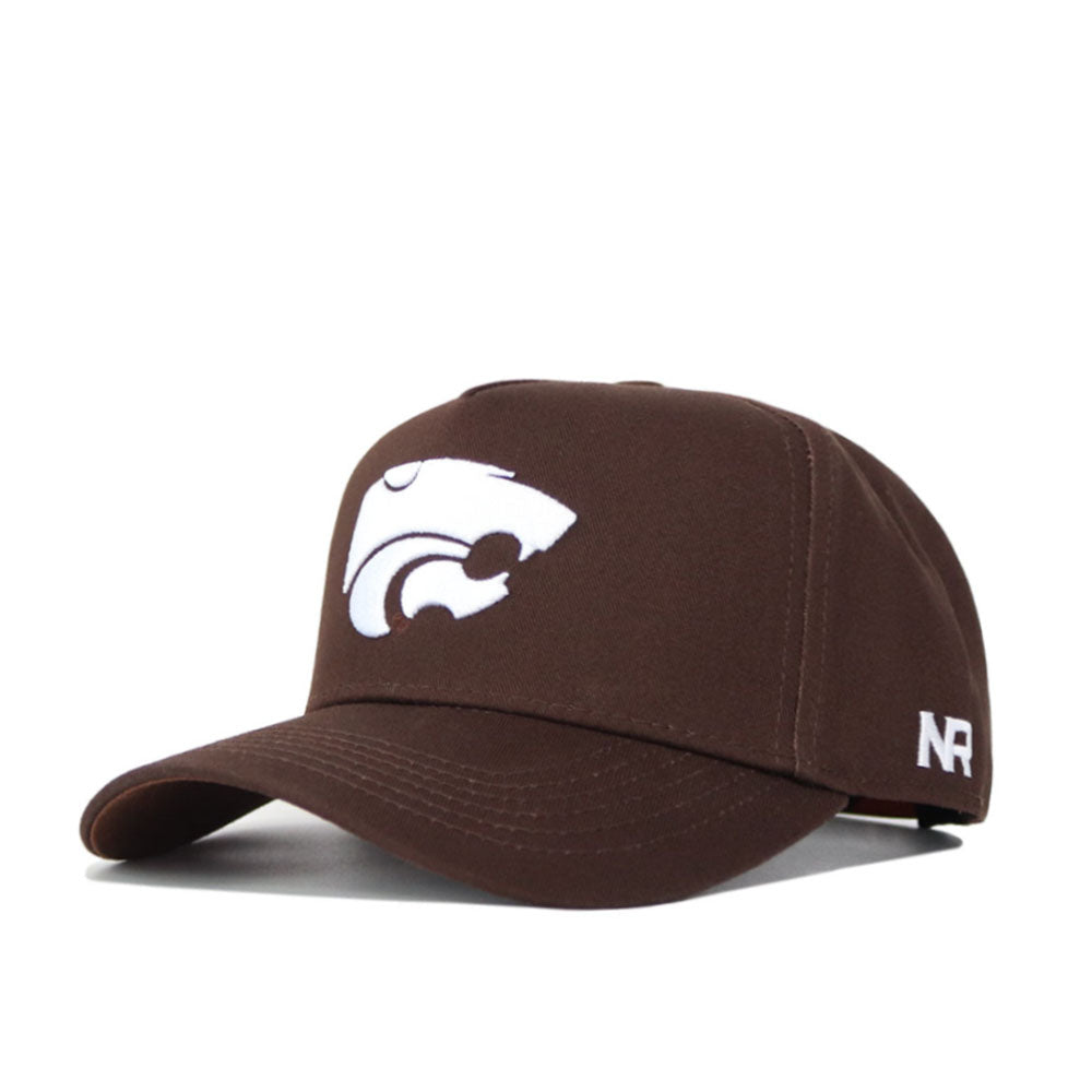 The Kansas State Americano Hat is a brown cotton baseball cap with a white wildcat logo on the front and white NR lettering on the side, displayed against a plain background.