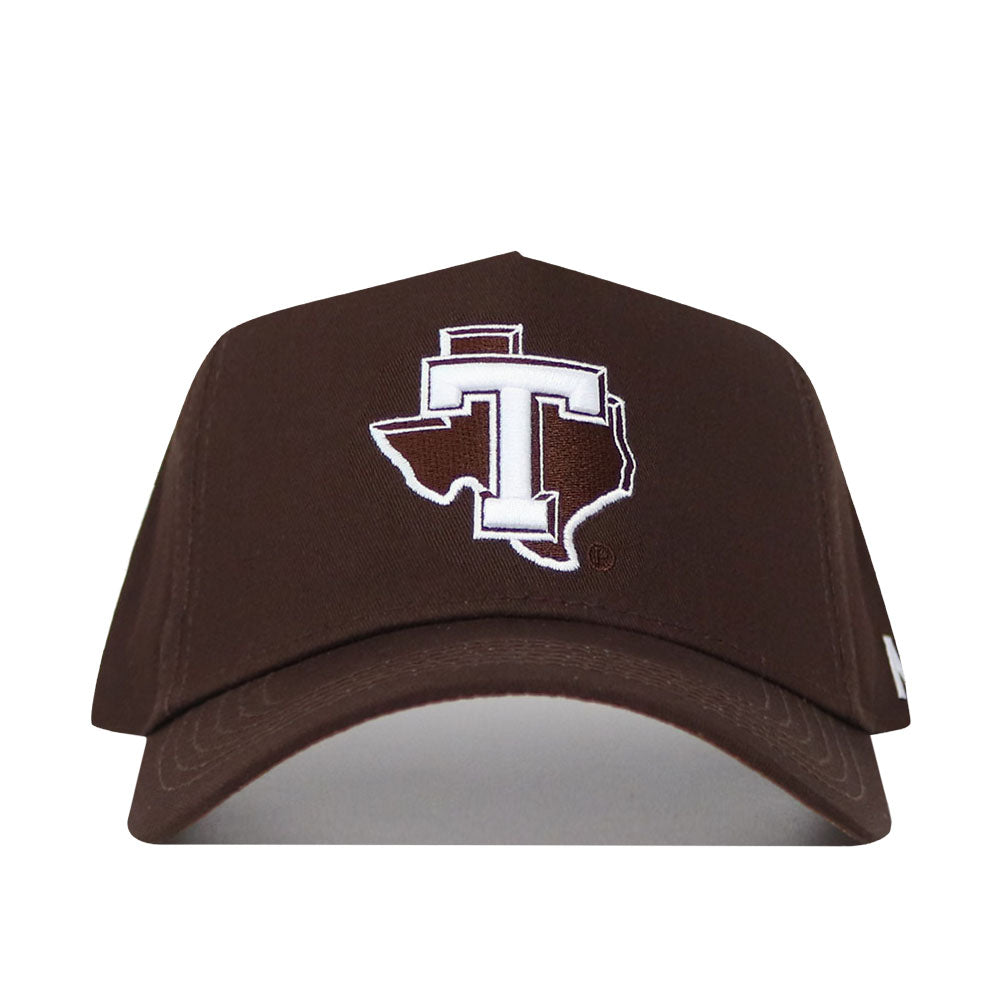The Tarleton Americano Hat is a brown snapback crafted from high-quality cotton, featuring a structured fit and a bold white "T" centered in an outlined Texas shape on the front.
