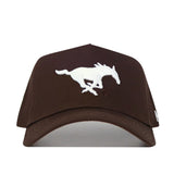 The SMU Americano Hat is a brown snapback made of high-quality cotton, with a white embroidered running horse logo on the structured front panel, shown from the front against a white background.