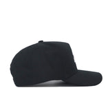 The Purdue Americano Hat, a plain black baseball cap made from high-quality cotton, is shown in side profile against a white background. It features a curved brim with no visible logos or designs on the visible side.