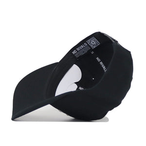 A bottom view of the Purdue Americano Hat, a black snapback, shows the inside band labeled "NO RIVALS" in white and a QR code on the high-quality cotton fabric near the adjustable strap.