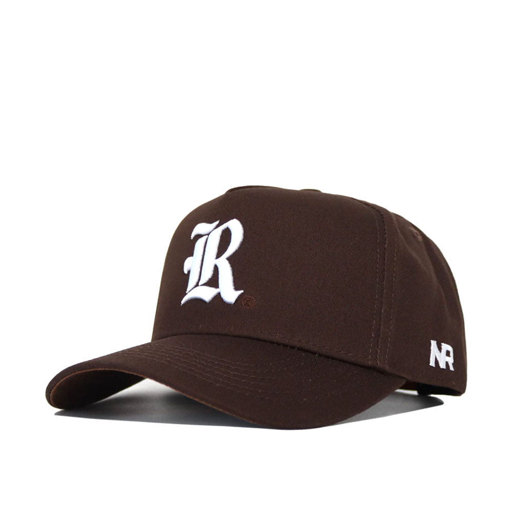 The Rice Americano Hat is a brown baseball cap with a structured fit, featuring a white embroidered R on the front and white NR lettering on the side, displayed against a plain white background.