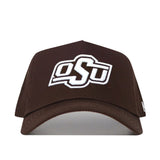 The Oklahoma State Americano Hat is an officially licensed brown cotton baseball cap with white embroidered OSU letters on the front, shown against a plain white background.