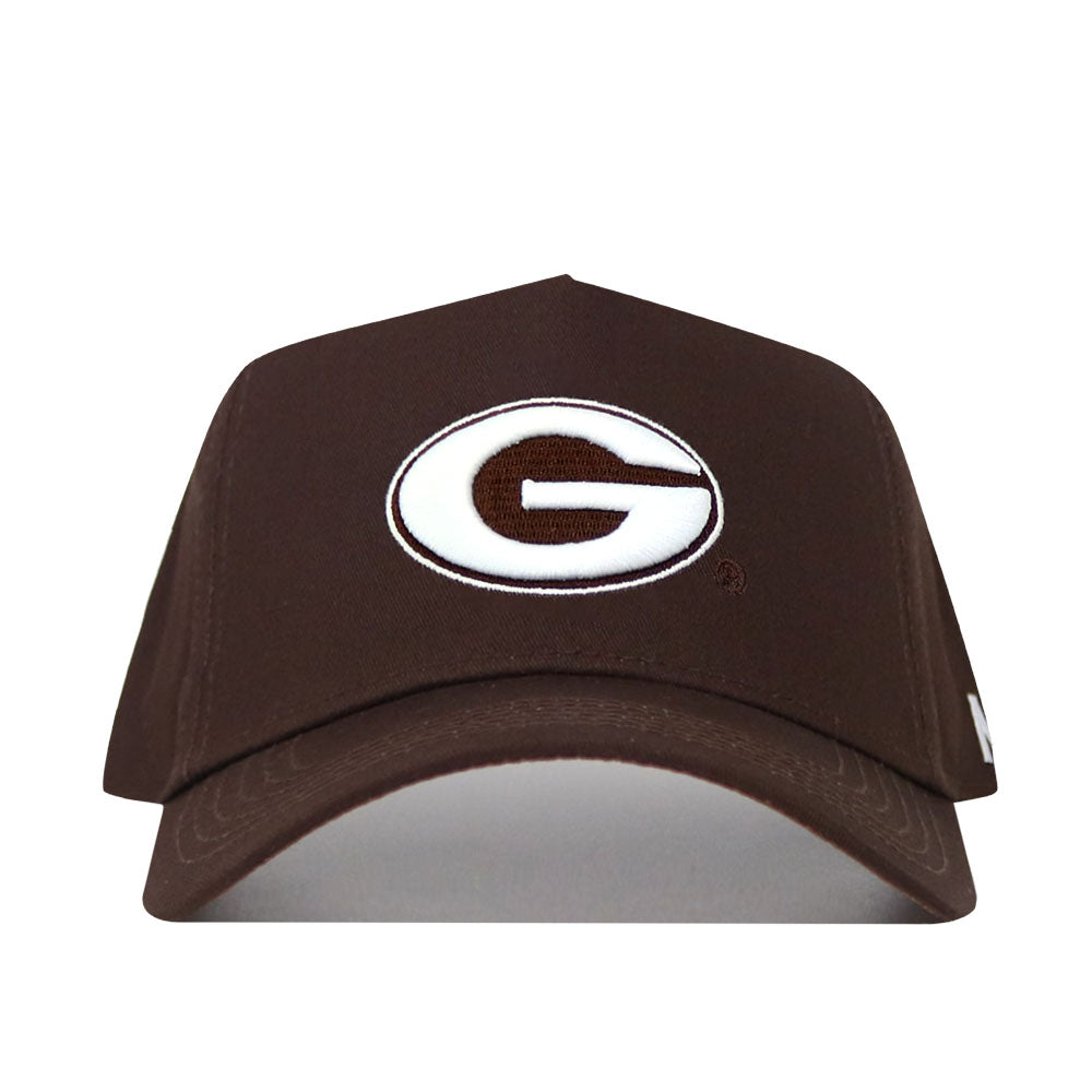The Georgia Americano Hat is a brown snapback made from high-quality cotton, featuring a white oval emblem with a bold brown "G" outlined in black on the front for a comfortable, structured fit.
