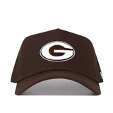The Georgia Americano Hat is a brown snapback made from high-quality cotton, featuring a white oval emblem with a bold brown "G" outlined in black on the front for a comfortable, structured fit.