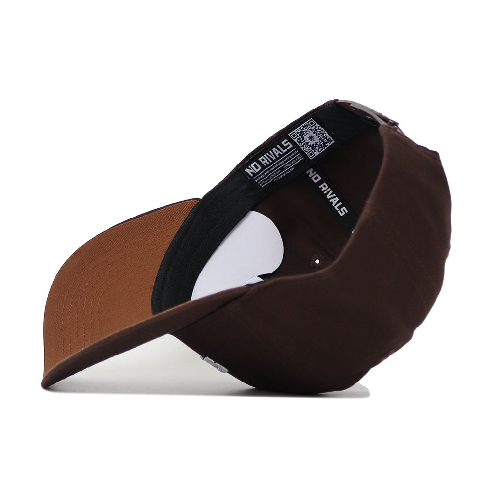 The Iowa State Americano Hat, a brown cotton cap with a structured fit, is shown upside down to display the inner lining featuring "NO RIVALS" and a QR code on the band. The snapback rests on a white surface.