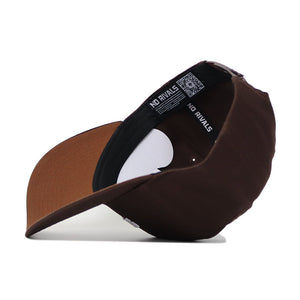 The Iowa State Americano Hat, a brown cotton cap with a structured fit, is shown upside down to display the inner lining featuring "NO RIVALS" and a QR code on the band. The snapback rests on a white surface.