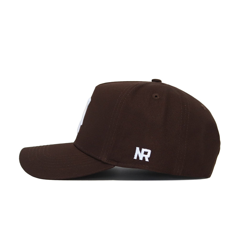 The Michigan State Americano Hat is a brown baseball cap with a structured fit, curved brim, and white NR initials embroidered on the back side panel.