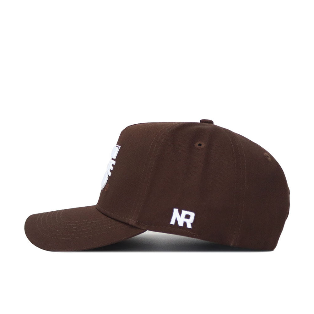 The Utah State Americano Hat is a brown snapback, seen from the side. It features white embroidered "NR" near the back and a partially visible white design on the front. Made of high-quality cotton with a structured fit, shown on a white background.