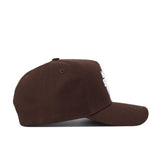 The Utah State Americano Hat is a brown cotton baseball cap with a curved brim and six-panel design, shown from the side against a white background.