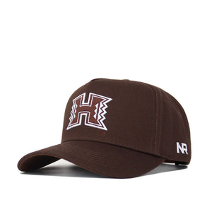 The Hawaii Americano Hat is a brown baseball cap featuring a white and brown embroidered H logo on the front, white NR letters on the side, and a snap back closure for a structured fit.