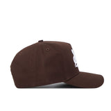 The Mississippi State Americano Hat is a brown snapback shown from the side, featuring white embroidered lettering on the front, stitched eyelets on the crown, and a structured fit made from high-quality cotton.