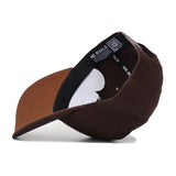 The NDSU Americano Hat is shown upside down, displaying a black inner lining with NO RIVALS text on the band, a QR code label inside, and an adjustable snap back closure.