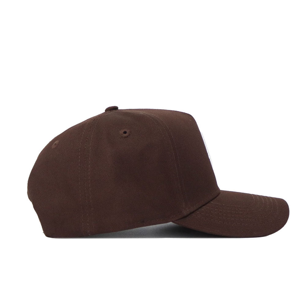 The Louisville Americano Hat is a plain brown snapback made from high-quality cotton, featuring a curved brim and top button, displayed from the side against a white background.