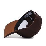 The Louisville Americano Hat is a brown snapback, turned inside out to reveal a black inner band with "NO RIVALS" in white, a QR code tag, and the brown underside—crafted from high-quality cotton for a structured fit.