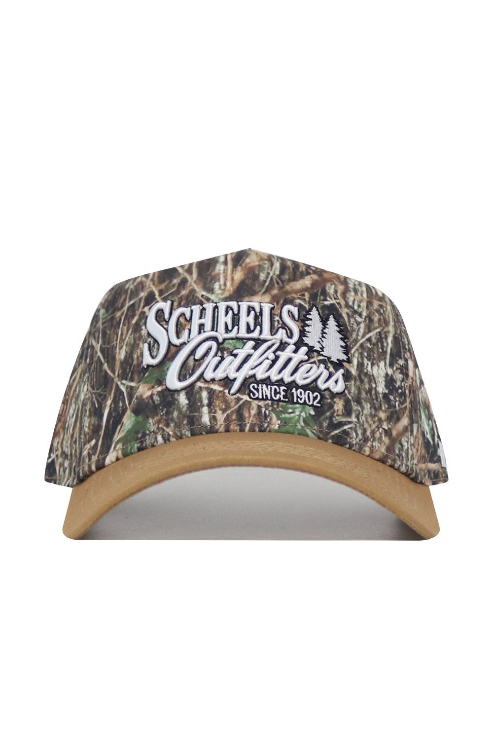 The Scheels Camo Explorer Hat is a camouflage baseball cap with a tan brim, structured fit, snapback closure, white “Scheels Outfitters Since 1902” embroidery, and two tree graphics on the front.