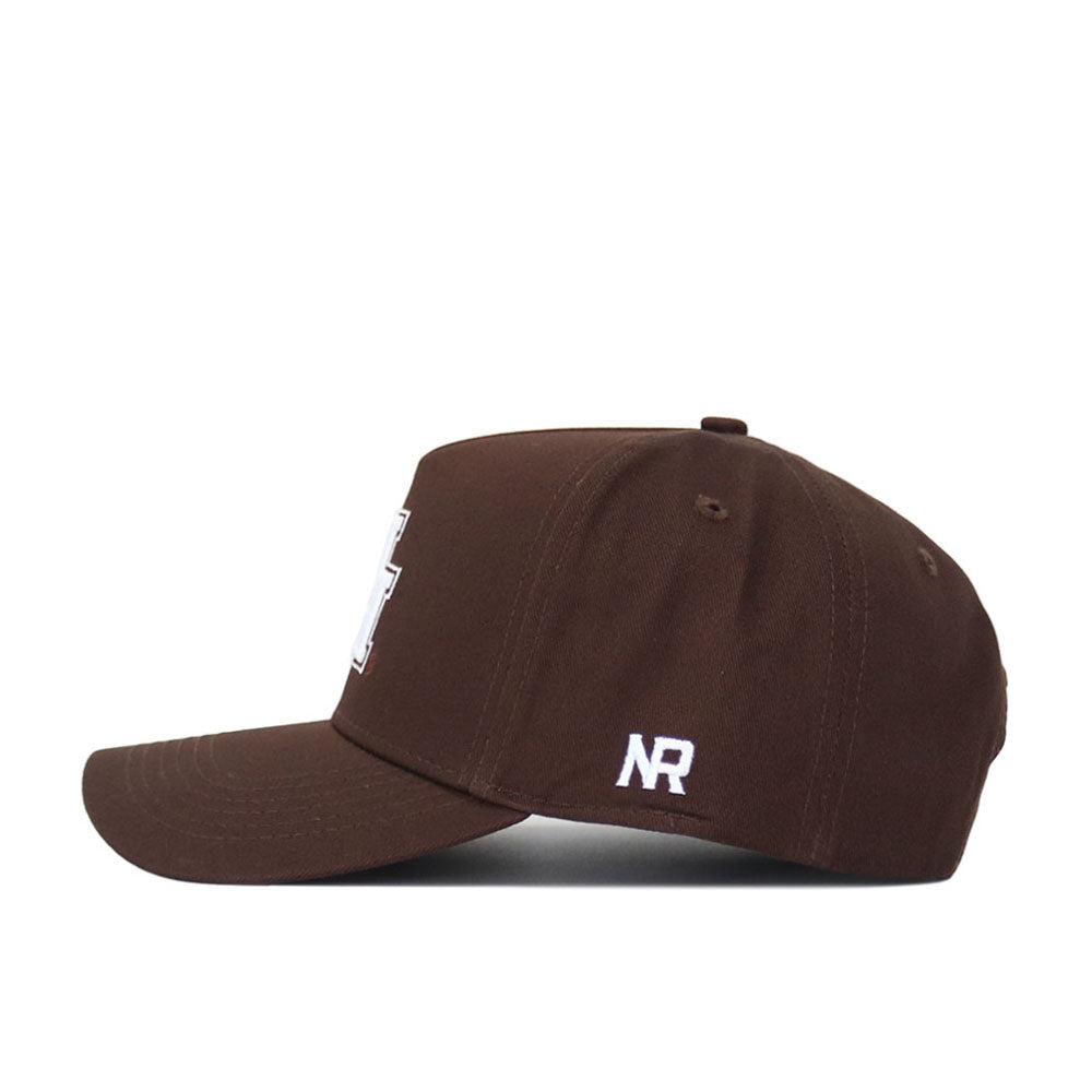 The Houston Americano Hat is a brown snapback seen from the side, showcasing white embroidered "NR" on the side panel and part of a white front design. Made from high-quality cotton with a structured fit for lasting comfort.