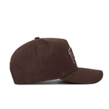 The University of Las Vegas (UNLV) Americano Hat is a brown structured-fit cap with a curved brim, raised front stitching, quality cotton build, ventilation eyelets, and a top button, shown here in a side view.