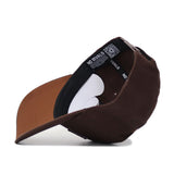 The University of Las Vegas (UNLV) Americano Hat features a brown structured fit, visible black and white inner lining, tags, stitching detail, and an inside label reading NO RIVALS on this premium cotton snapback.