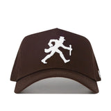 The Wake Forest Americano Hat is a brown snapback made from high-quality cotton, featuring a white embroidered man in a top hat walking with a cane on the front.