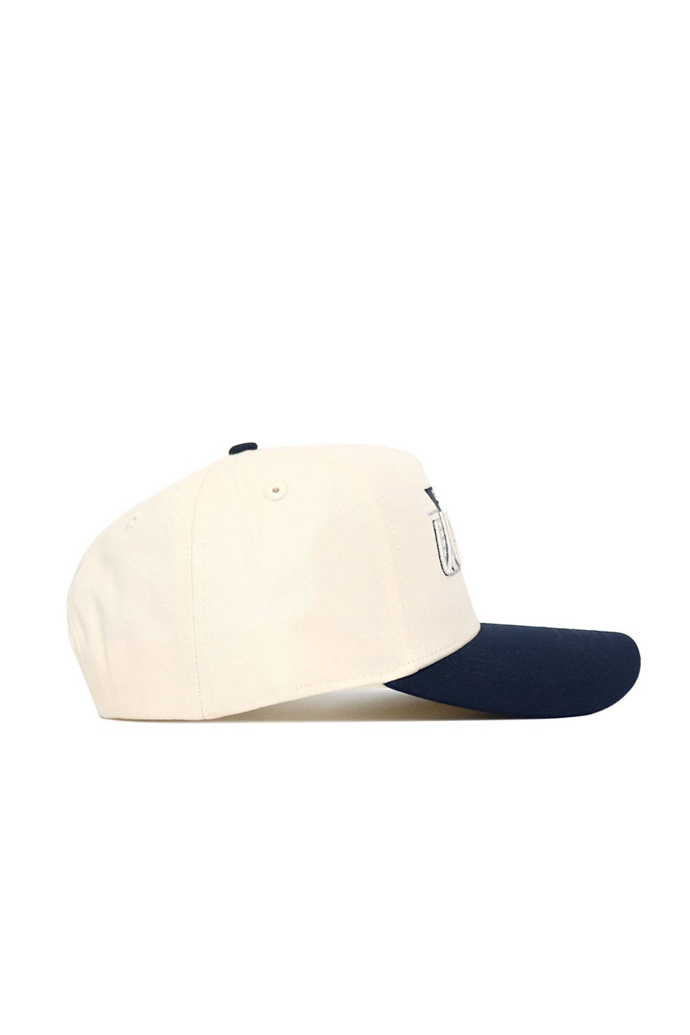 The UConn Triangle Game Cap Hat features a cream-colored crown, navy blue brim, and premium cotton construction, displayed side-on against a white background.