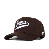 The Iowa Americano Hat is a brown snapback made from high-quality cotton, with "Iowa" embroidered in white script on the front and "NR" stitched in white on the left side.