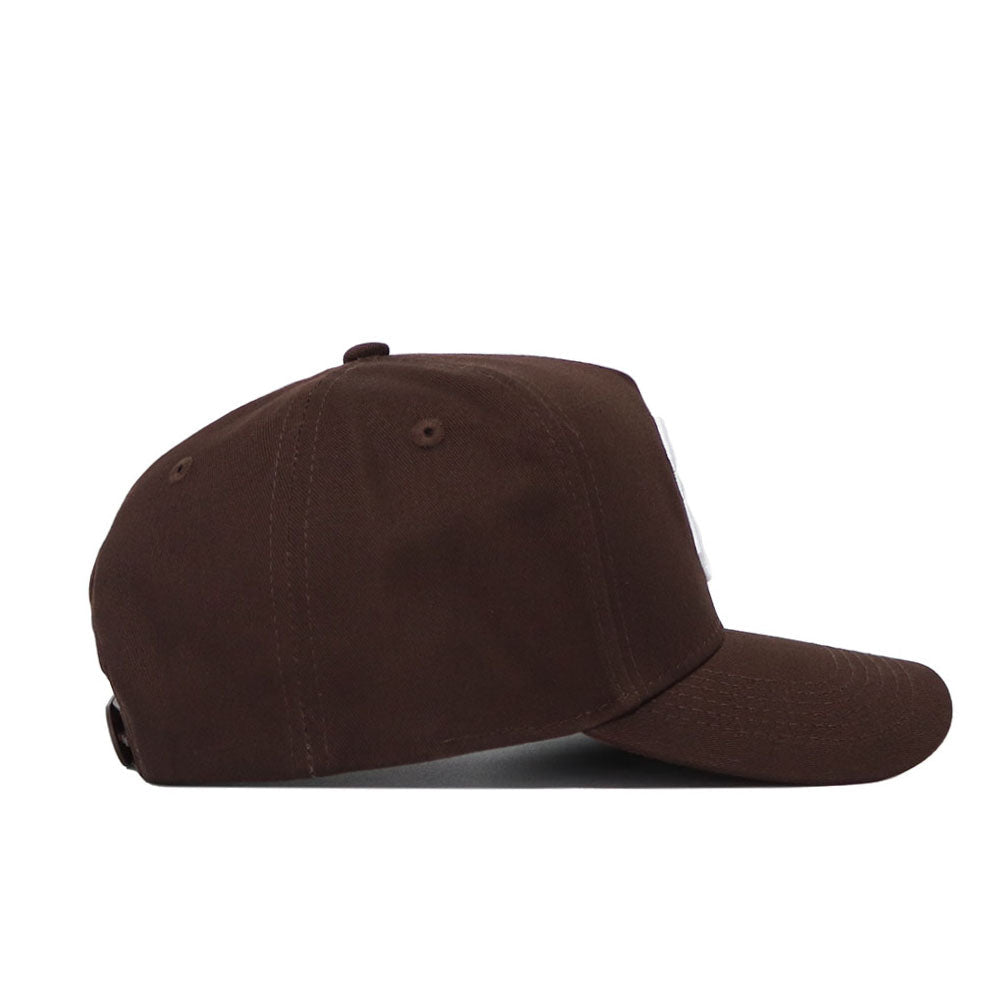 The South Carolina Americano Hat is a brown snapback with a curved brim, structured fit, and adjustable back strap. Made from high-quality cotton for lasting comfort, shown here from the side.