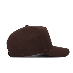 The South Carolina Americano Hat is a brown snapback with a curved brim, structured fit, and adjustable back strap. Made from high-quality cotton for lasting comfort, shown here from the side.