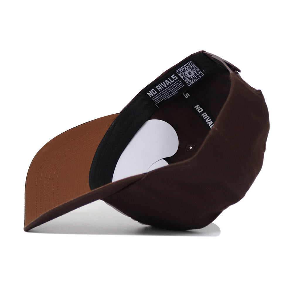 The South Carolina Americano Hat is shown upside down, revealing an inside label with "NO RIVALS" and a QR code. It features a brown snapback design, curved bill, adjustable strap, and structured fit to maintain its shape.