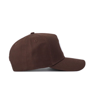 The Colorado State Americano Hat is a brown cotton baseball cap with a curved brim, top button, and structured fit. Shown from the side, it has a plain design with minimal visible details or logos.