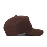 The Kentucky Americano Hat is a brown baseball cap with a white logo, structured fit, and an adjustable snap back closure for style and comfort.