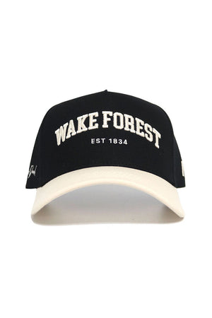 The No Rivals WAKE FOREST Established Hat is a black cap with a white brim, featuring "WAKE FOREST EST 1834" embroidered in white. Officially licensed, it’s made from high quality cotton and has an adjustable snap back for the perfect fit.